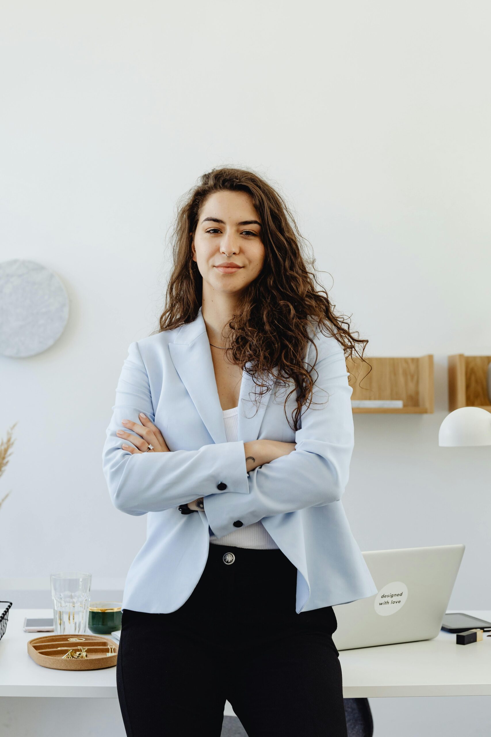 HR Professional standing in a serious, triumphant pose with their arms crossed